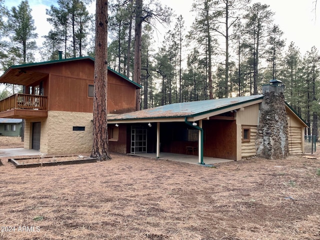 rear view of property featuring a balcony