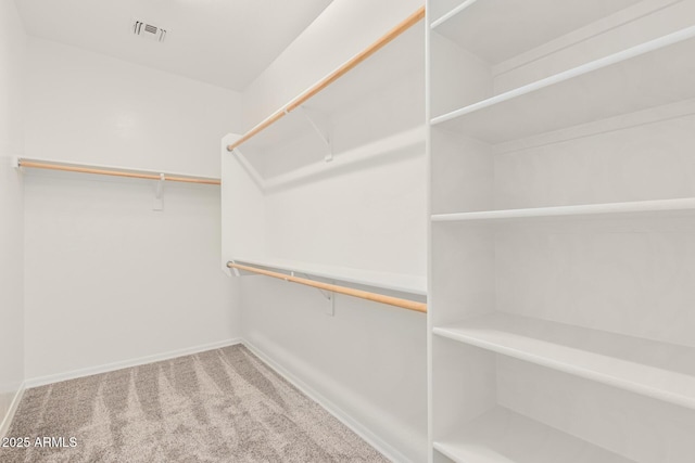 spacious closet with visible vents and carpet flooring