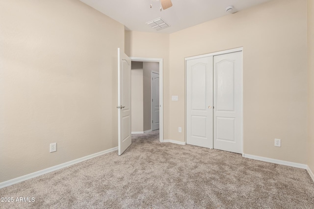 unfurnished bedroom featuring a closet, visible vents, carpet flooring, ceiling fan, and baseboards