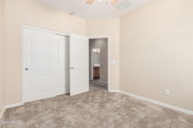 unfurnished bedroom with ceiling fan, carpet floors, visible vents, baseboards, and a closet