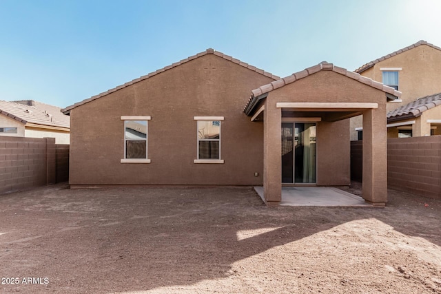 rear view of property with a patio area, a fenced backyard, and stucco siding