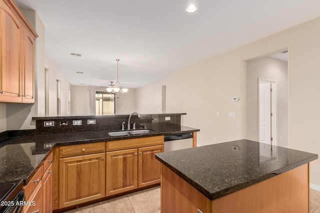 kitchen featuring electric range oven, a peninsula, a sink, a chandelier, and stainless steel dishwasher