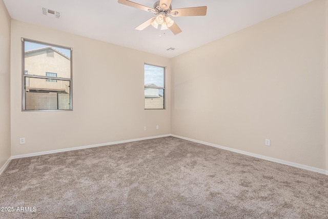 empty room with baseboards, carpet, visible vents, and a ceiling fan