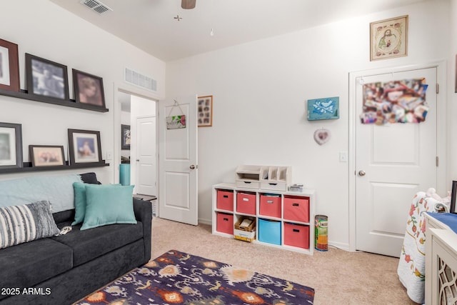 recreation room with ceiling fan and light colored carpet