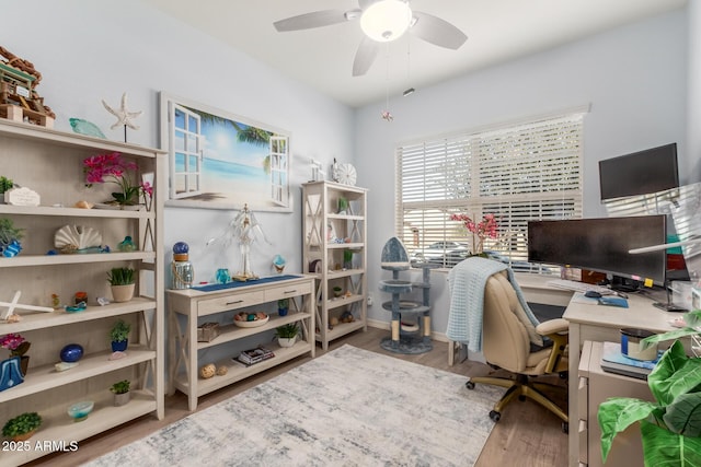 office with hardwood / wood-style flooring and ceiling fan