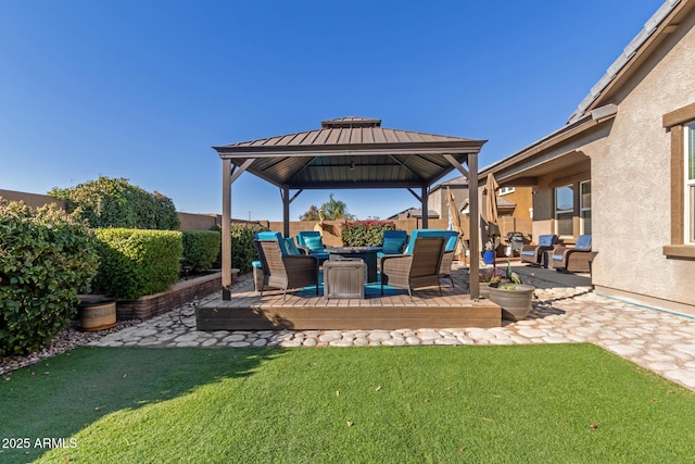 view of patio / terrace featuring a gazebo, a deck, and fence