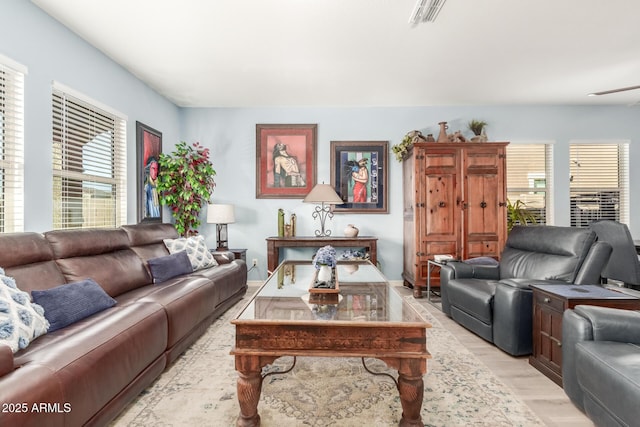 living room with light wood-style floors and visible vents