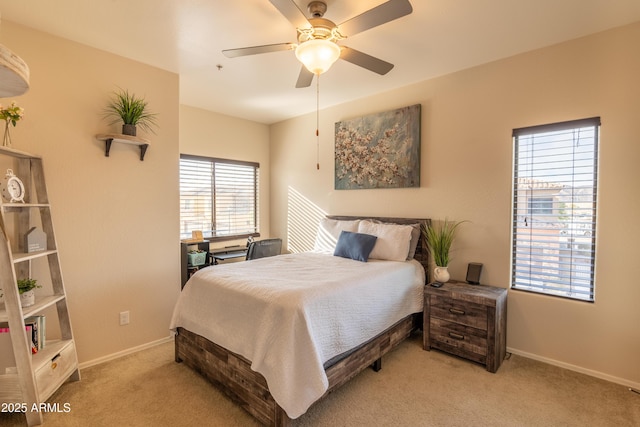 bedroom with multiple windows, light colored carpet, and ceiling fan