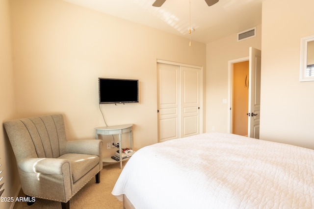 carpeted bedroom featuring ceiling fan and a closet