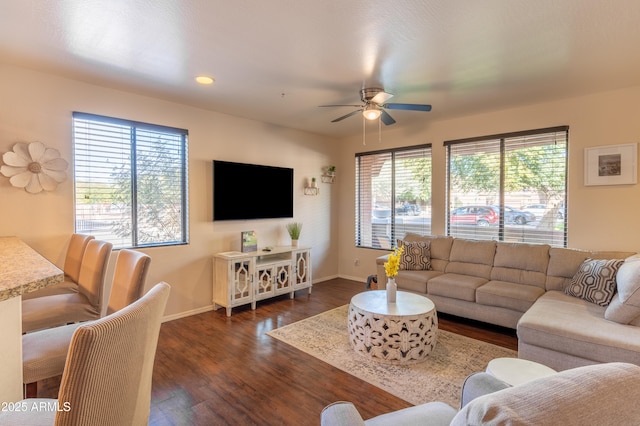 living room featuring dark hardwood / wood-style flooring and ceiling fan