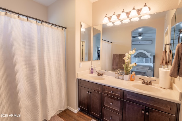 bathroom featuring hardwood / wood-style flooring, ceiling fan, a shower with curtain, and vanity