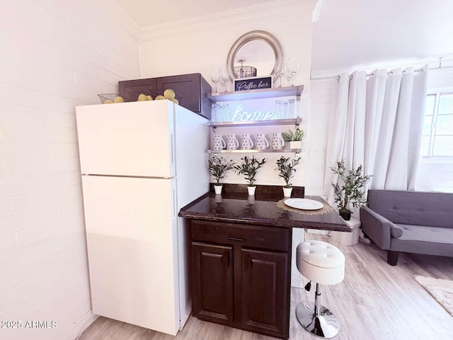 2150 W Missouri Ave Unit 120, Phoenix, AZ 85015 - bar featuring freestanding refrigerator, light wood finished floors, and ornamental molding