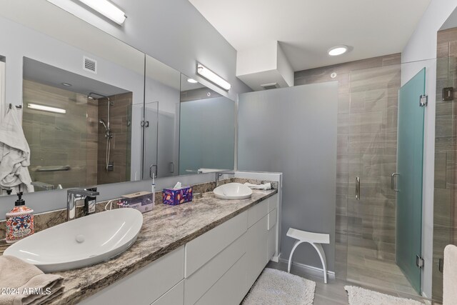 bathroom with vanity, wood-type flooring, and walk in shower