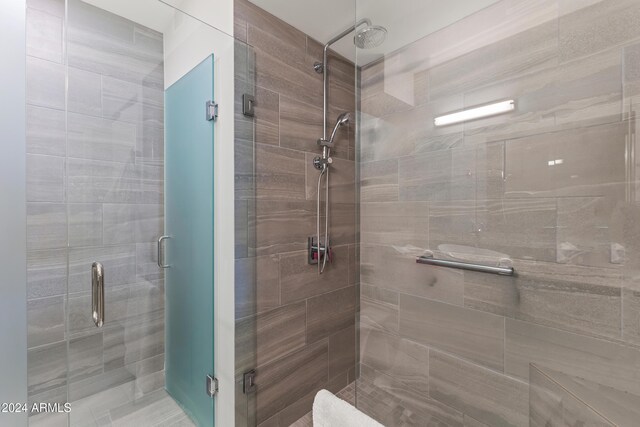 bathroom featuring a shower with shower door