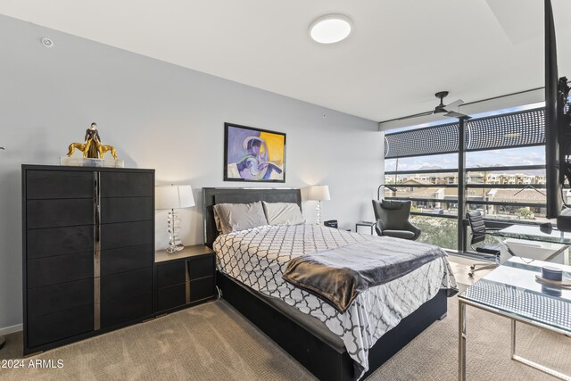 bedroom featuring ceiling fan and light carpet