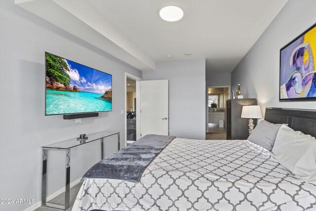 carpeted bedroom featuring ensuite bath