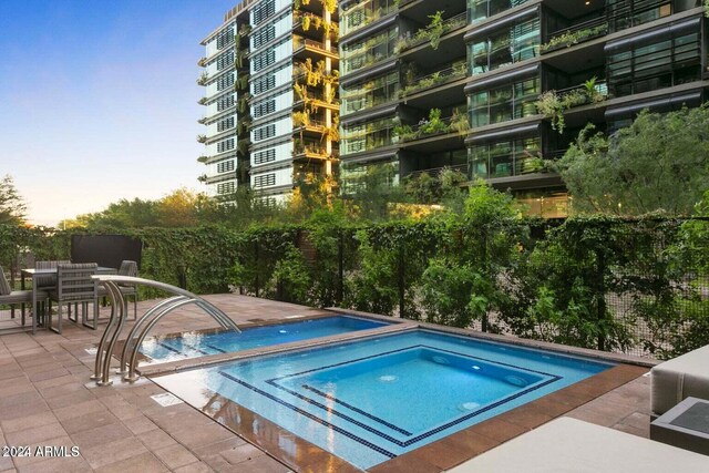 view of pool with a community hot tub