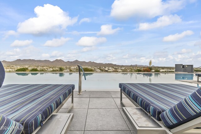 view of patio with a water and mountain view