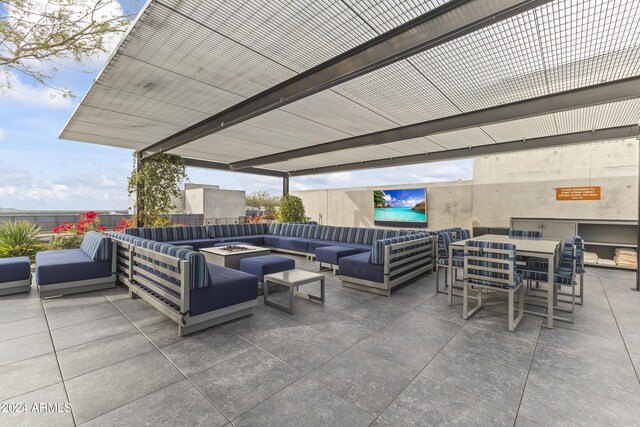 view of patio / terrace featuring an outdoor living space with a fire pit