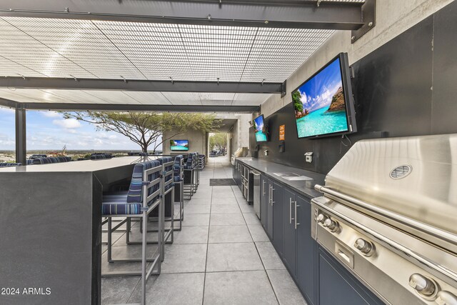 view of patio featuring exterior bar and grilling area