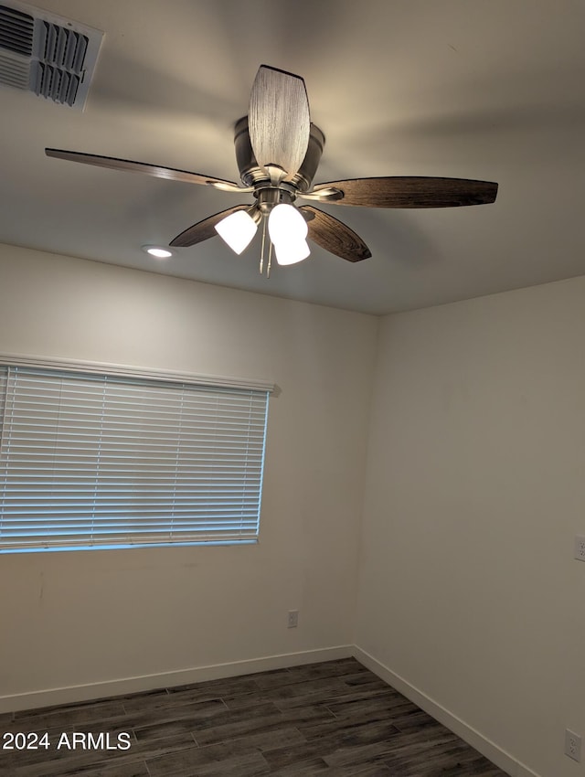 spare room featuring ceiling fan and dark hardwood / wood-style floors