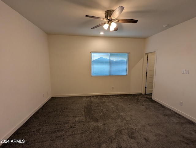 carpeted spare room with ceiling fan