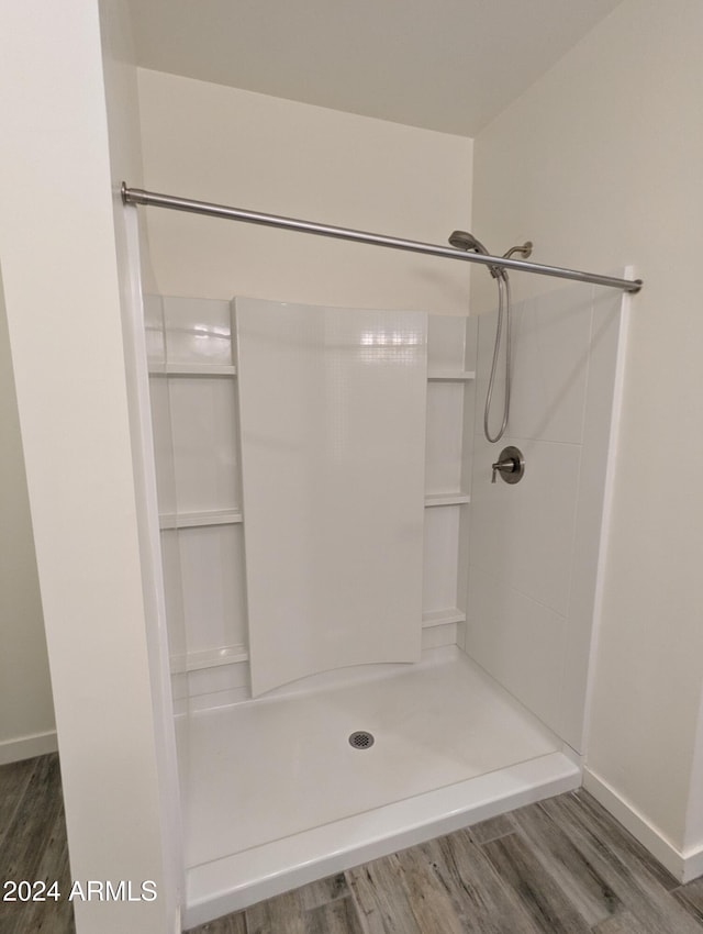 bathroom featuring wood-type flooring and walk in shower