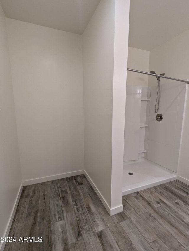 bathroom with a shower and hardwood / wood-style flooring