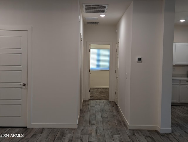 hallway with dark hardwood / wood-style floors