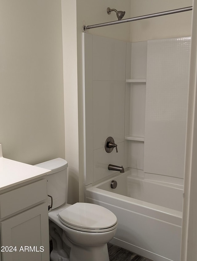 full bathroom with vanity, hardwood / wood-style floors, toilet, and tub / shower combination