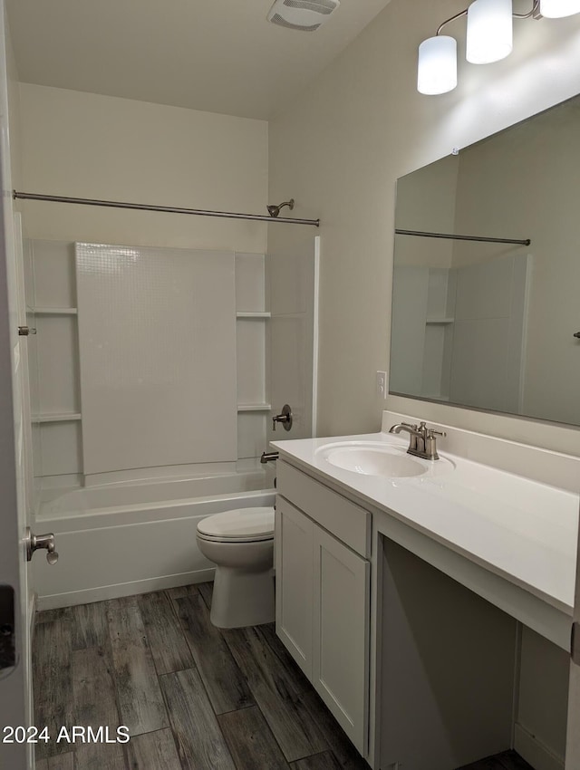 full bathroom featuring vanity, toilet, wood-type flooring, and tub / shower combination