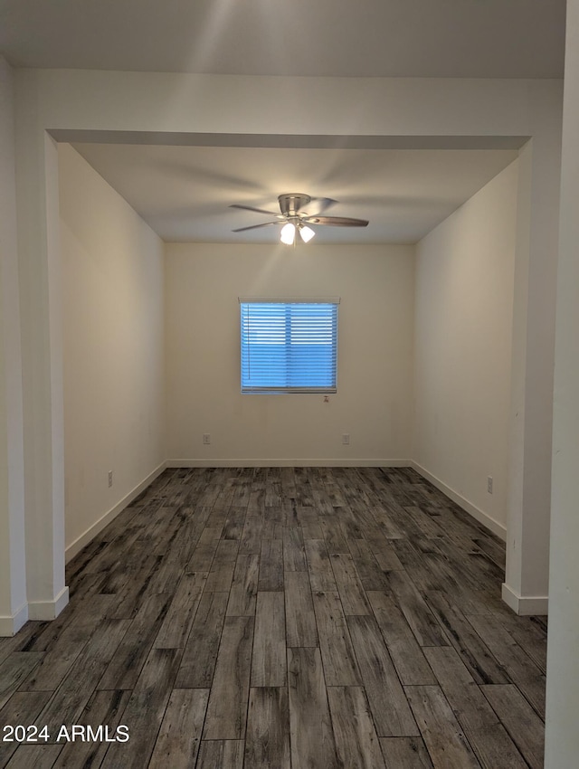 spare room with ceiling fan and dark hardwood / wood-style flooring