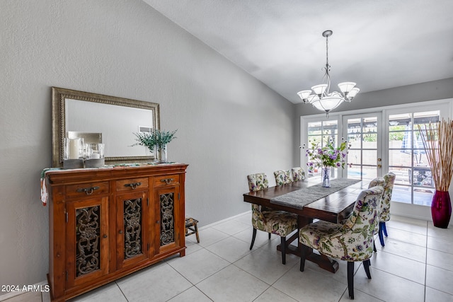 dining area featuring lofted ceiling, light tile patterned flooring, and a notable chandelier