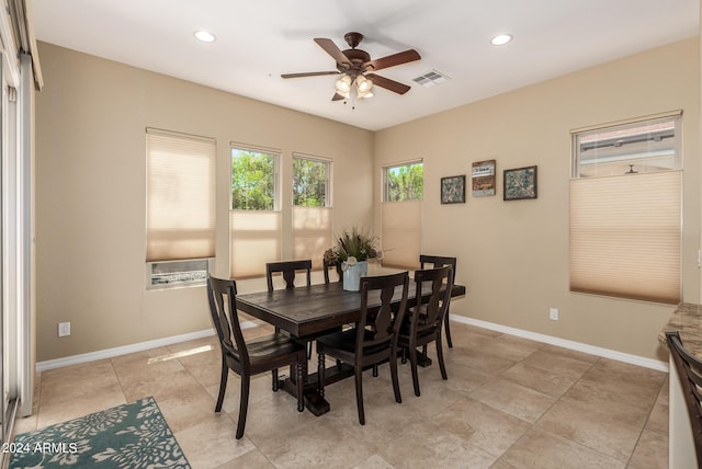 tiled dining space with ceiling fan