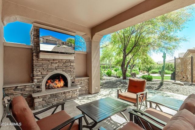 view of patio / terrace with an outdoor stone fireplace