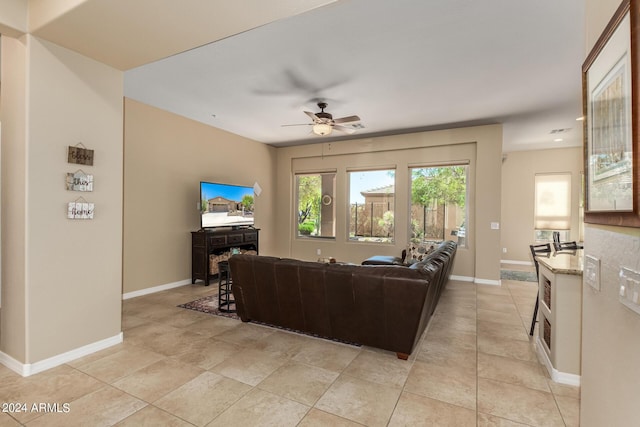 tiled living room with ceiling fan