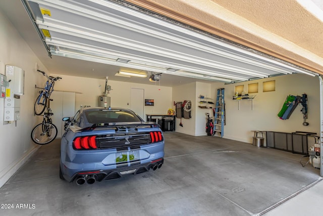 garage featuring water heater and a garage door opener