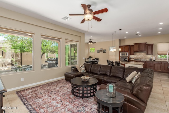 tiled living room with ceiling fan