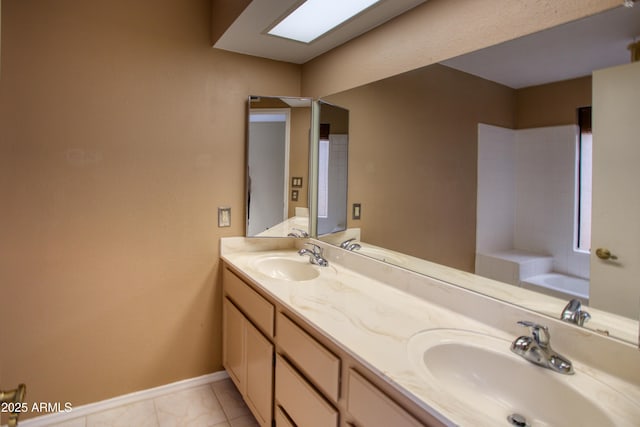 bathroom with vanity and a bath