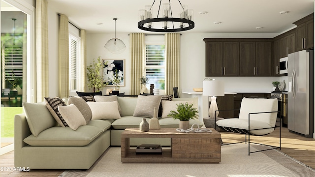 sitting room featuring an inviting chandelier and light wood-type flooring