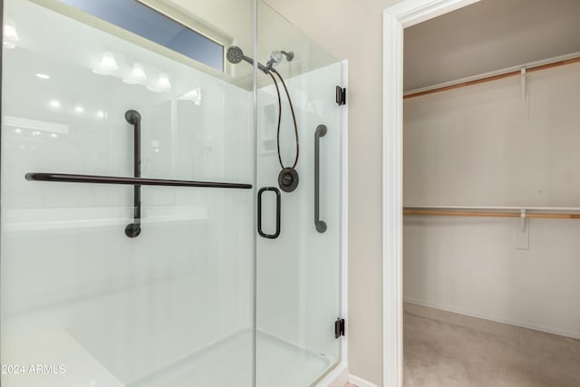 bathroom with a shower with door