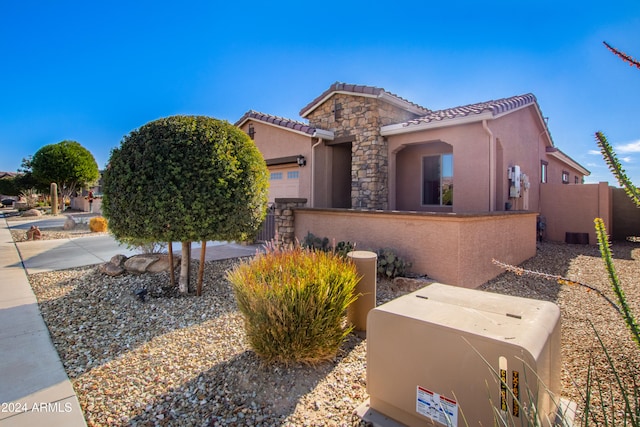 mediterranean / spanish house with a garage