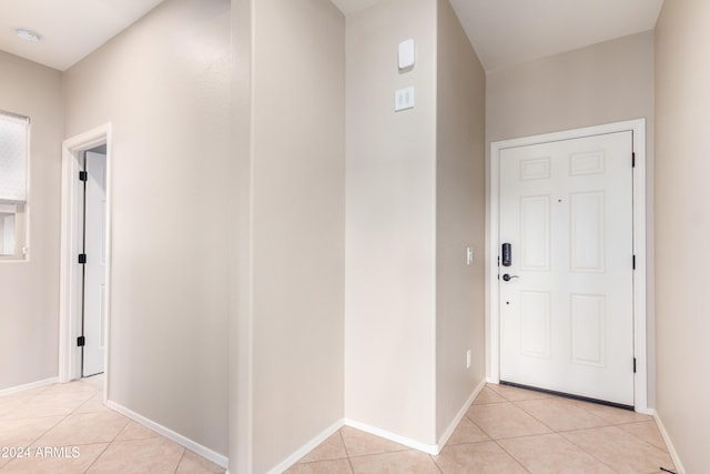 hall featuring light tile patterned floors