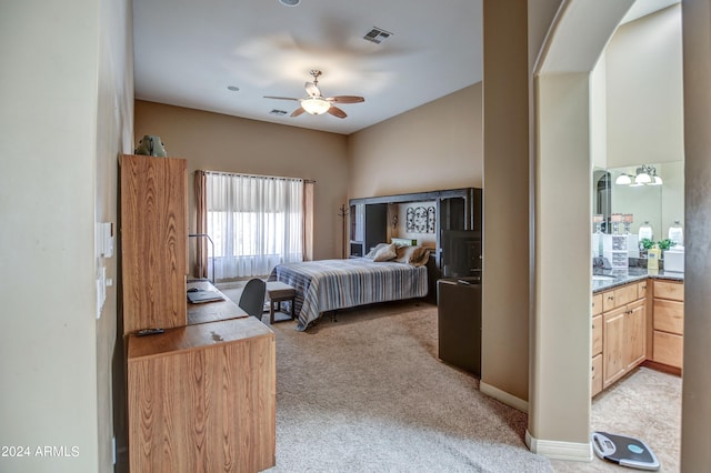 bedroom featuring a sink, visible vents, light carpet, and ceiling fan