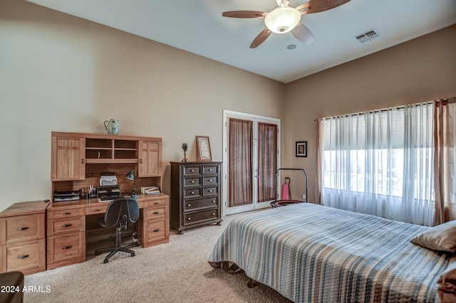 bedroom with ceiling fan, visible vents, and light carpet