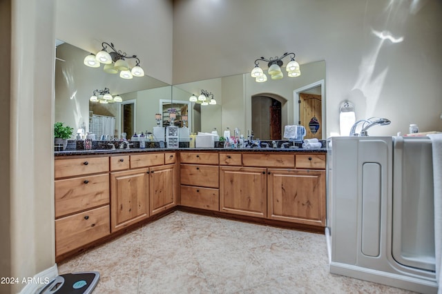 bathroom with a high ceiling and vanity