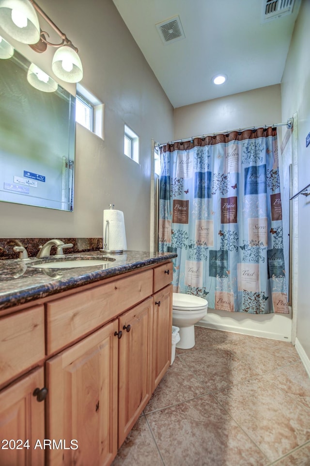 bathroom with visible vents, toilet, vanity, and tile patterned flooring