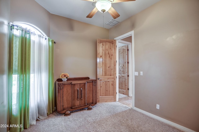 carpeted bedroom featuring visible vents, baseboards, and a ceiling fan