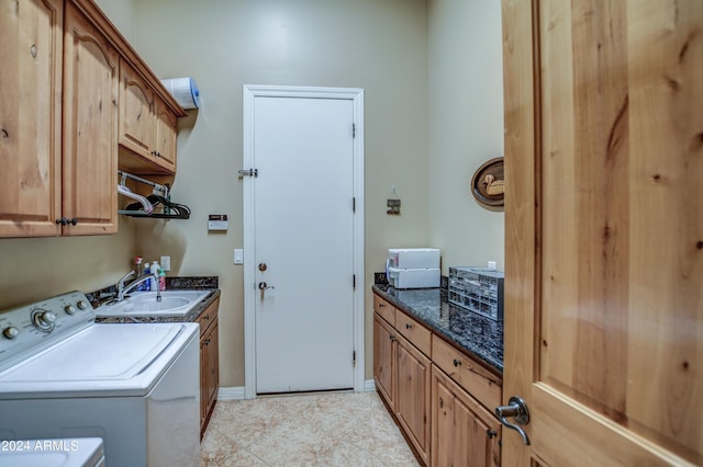 laundry area with separate washer and dryer, cabinet space, baseboards, and a sink