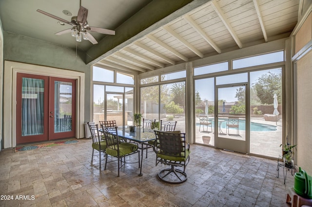 sunroom / solarium featuring beam ceiling, french doors, and a ceiling fan